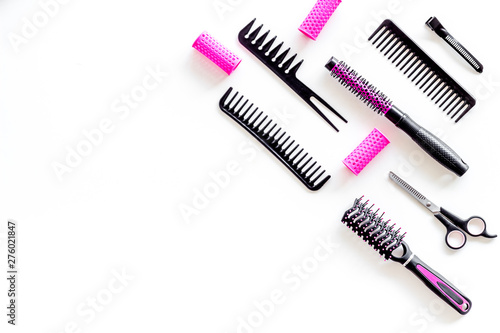Hairdresser equipment for cutting hair and styling with combs, sciccors, brushes on white background top view copyspace