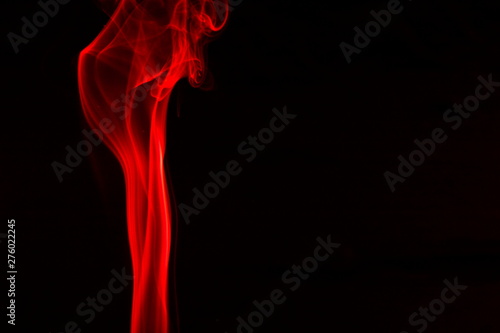 Red smoke on black background