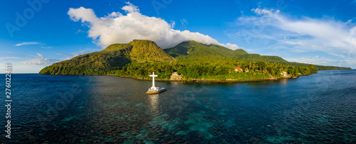 Aerial panorama of the Sunken Cemetery and background volcanos in the evening light on Camiguin Island, Philippines photo