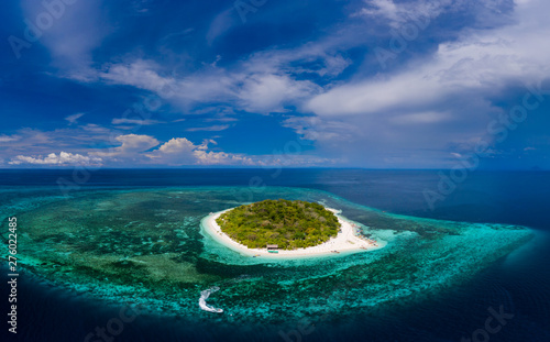 Aerial panorama of a beautiful tropical island and coral reef (Mantigue Island)