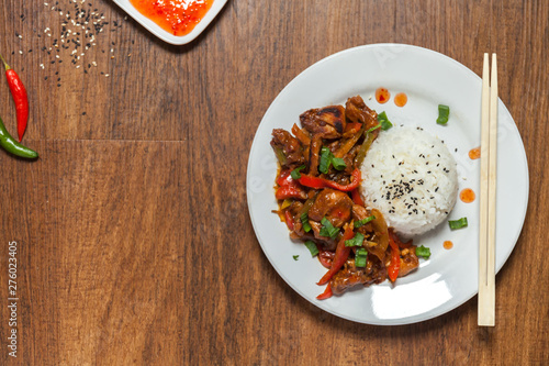 Sweet and Sour Chicken on Rice. Typical Asian dish. A lot of negative space for text. flat layout photo