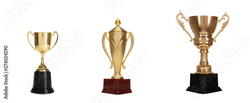Set of different shiny gold trophy cups on white background
