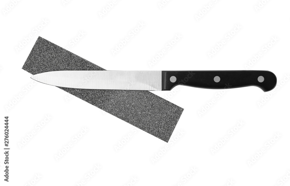 Utility knife and grindstone isolated on white, top view Utility knife and grindstone isolated on white, top view
