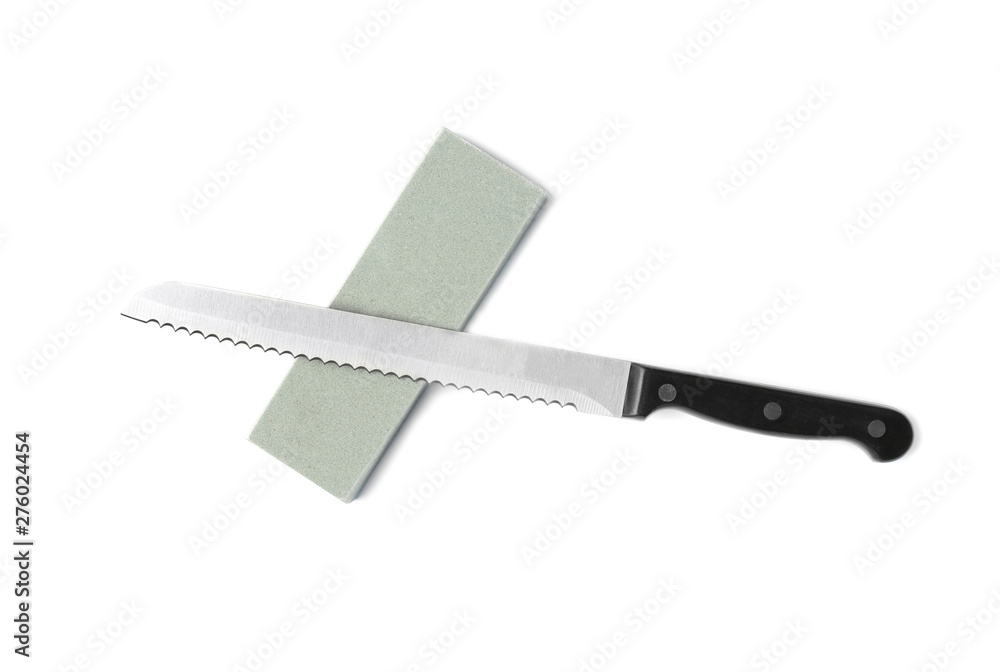 Bread knife and grindstone isolated on white, top view Bread knife and grindstone isolated on white, top view