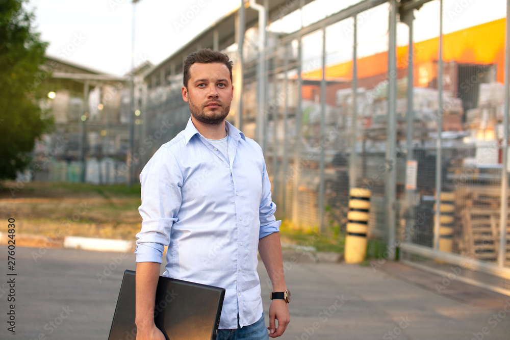 Fototapeta premium Portrait of sales representative. Logistics manager waiting his business partner to have a deal. Concept of warehouse outdoor and transportation services. .