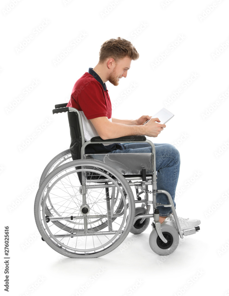 Young man in wheelchair using tablet isolated on white Young man in wheelchair using tablet isolated on white