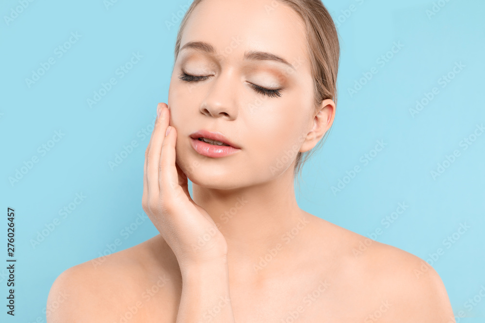 Portrait of young woman with beautiful face on blue background, closeup Portrait of young woman with beautiful face on blue background, closeup