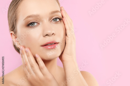 Portrait of young woman with beautiful face on pink background  closeup. Space for text