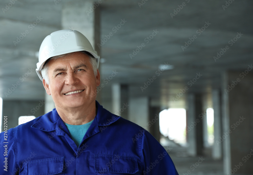 Professional builder at construction site, space for text. Safety equipment Professional builder at construction site, space for text. Safety equipment