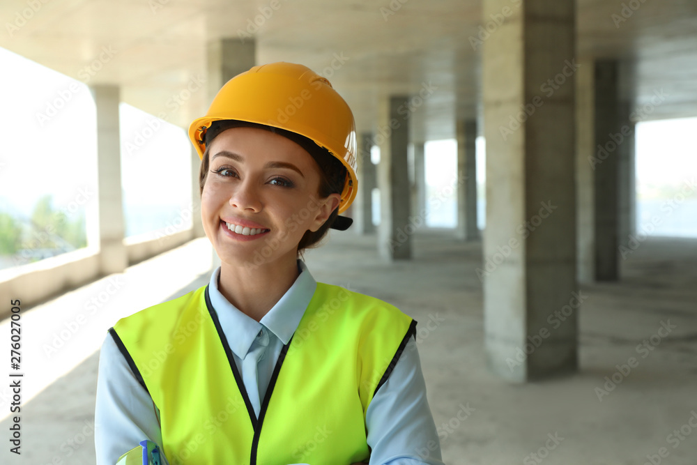 Professional engineer in safety equipment at construction site, space for text Professional engineer in safety equipment at construction site, space for text