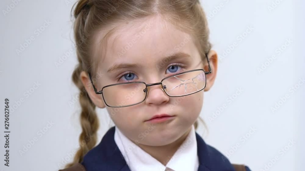 Upset girl in broken glasses looking at camera closeup, school bullying, abuse Upset girl in broken glasses looking at camera closeup, school bullying, abuse