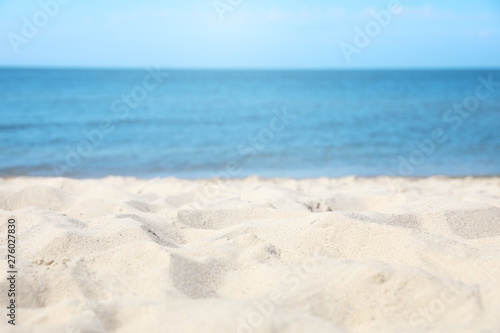 Sandy beach near sea on sunny day
