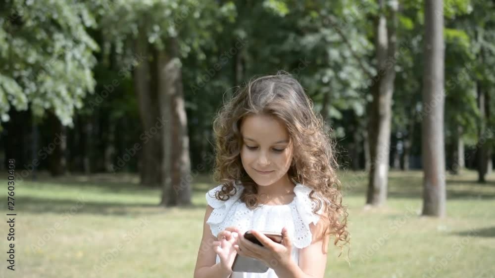 The girl looks into the phone on the background The girl looks into the phone on the background