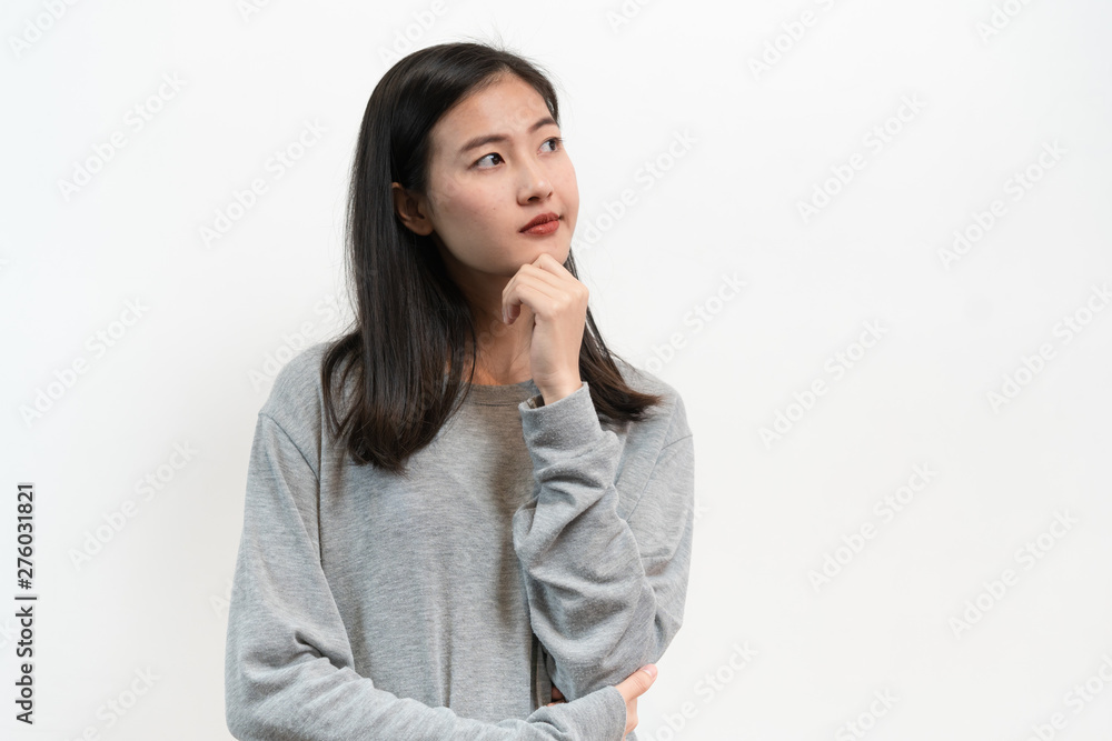 Asian young woman thoughtful thinking isolated on white back ground in studio. Asian young woman thoughtful thinking isolated on white back ground in studio.