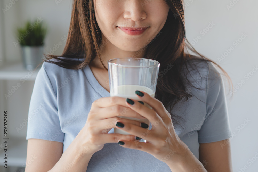 Close up view of asian woman drinking milk. Close up view of asian woman drinking milk.
