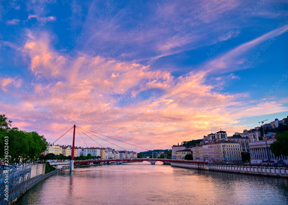Fototapeta premium A view of Lyon, France along the Saône river at sunset.