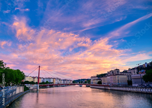A view of Lyon  France along the Sa  ne river at sunset.