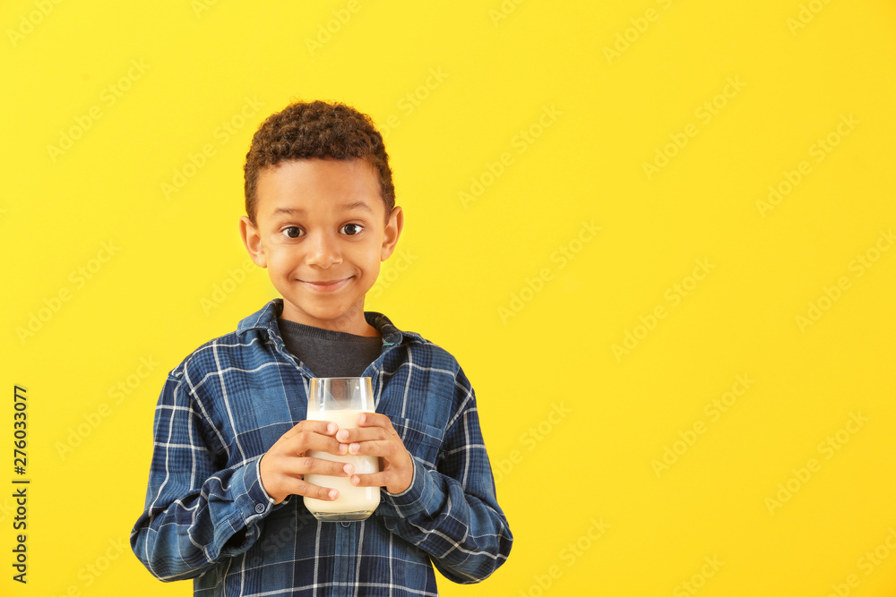 Cute African-American boy with glass of milk on color background Cute African-American boy with glass of milk on color background