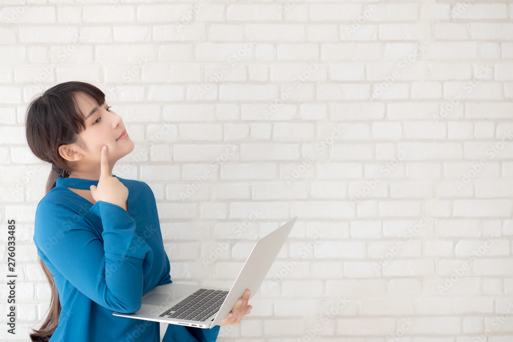 Beautiful asian young woman hipster using working laptop thinking idea on cement concrete background, girl doubt and question with computer internet online, freelance and business concept. Beautiful asian young woman hipster using working laptop thinking idea on cement concrete background, girl doubt and question with computer internet online, freelance and business concept.