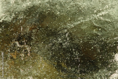 Close-up of bubbly, refreshing, clear Lake Fork Creek in Beartooth Mountains, Montana