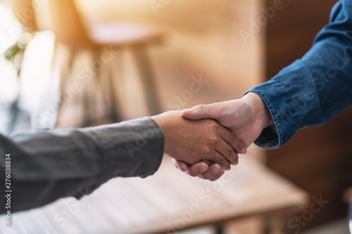 Closeup image of two people shaking hands
