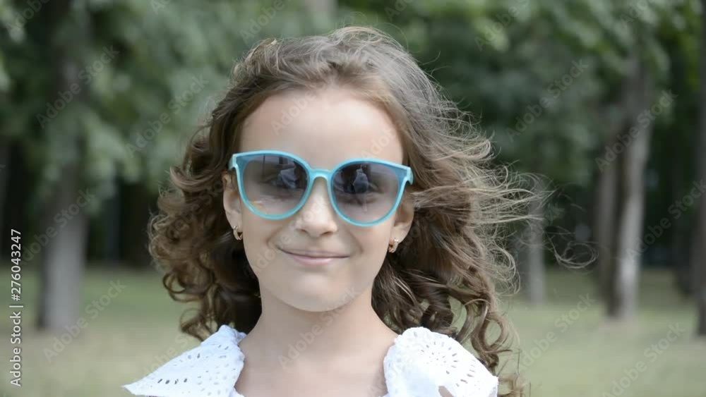 beautiful little girl six years old portrait in sunglasses in the park beautiful little girl six years old portrait in sunglasses in the park