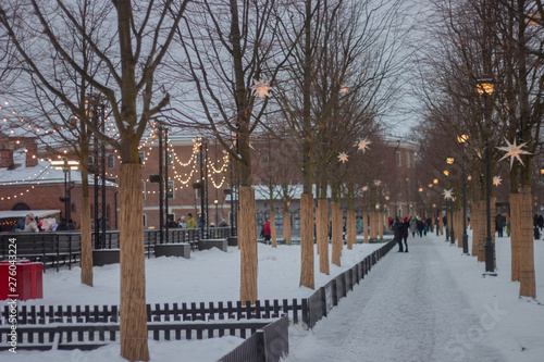 6.01.2019 new holland in winter. street decorated with lanterns and garlands with. people walk along a winter street