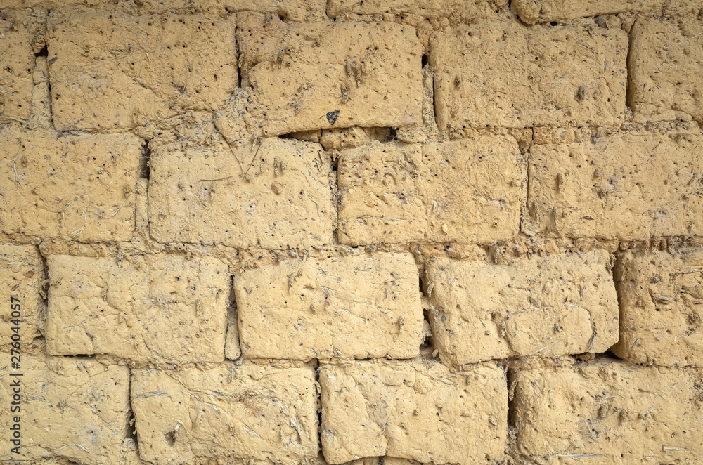 Fototapeta premium old yellow mud brick wall background