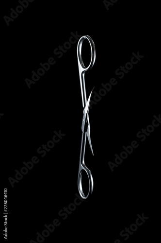 Neat little scissors for manicure and pedicure on a black background, isolate