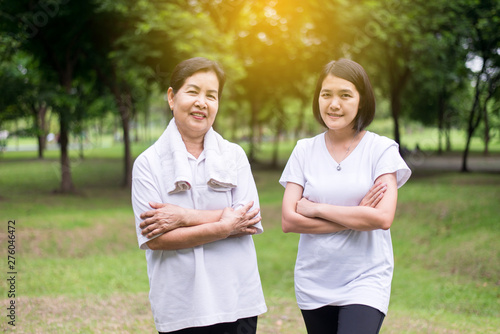 Portrait of sporty elderly asian woman with daughter exercise and workout at park together,Happy and smiling,Positive thinking