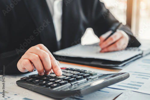 Business woman Accounting Financial investment on calculator Cost Economic business and market