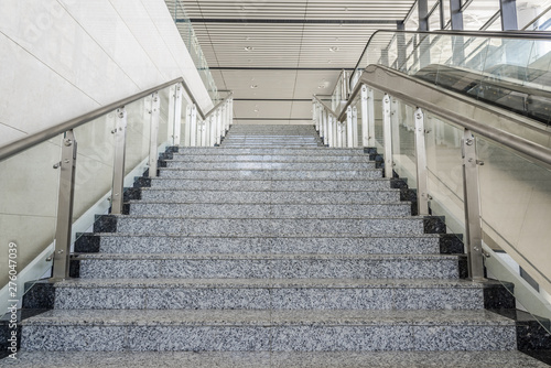 Perspective of clean marble steps and glass steel handrails in the building hall now © bqmeng