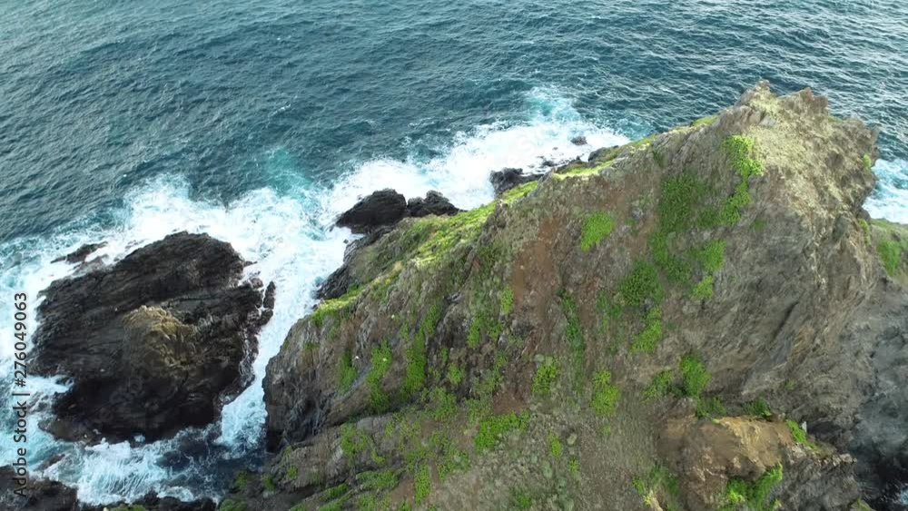 Aerial view of Lanikai beach, Honolulu, Hawaii, bird eye view with drone camera tilt shot, green island in the middle of the bay, color graded Aerial view of Lanikai beach, Honolulu, Hawaii, bird eye view with drone camera tilt shot, green island in the middle of the bay, color graded