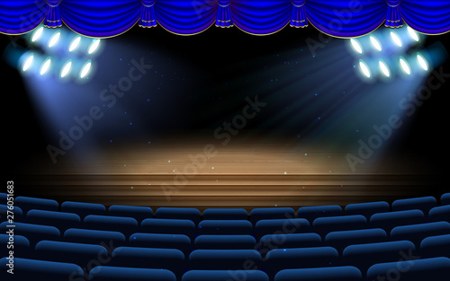 blue spotlight on the stage with blue chairs in the hall
