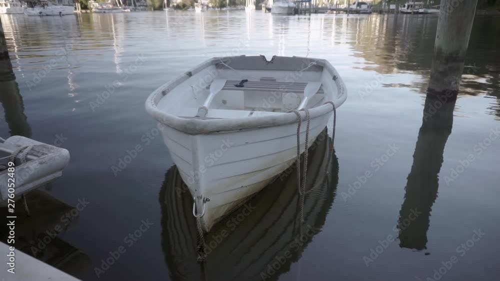 Empty white boat at the river dock Empty white boat at the river dock