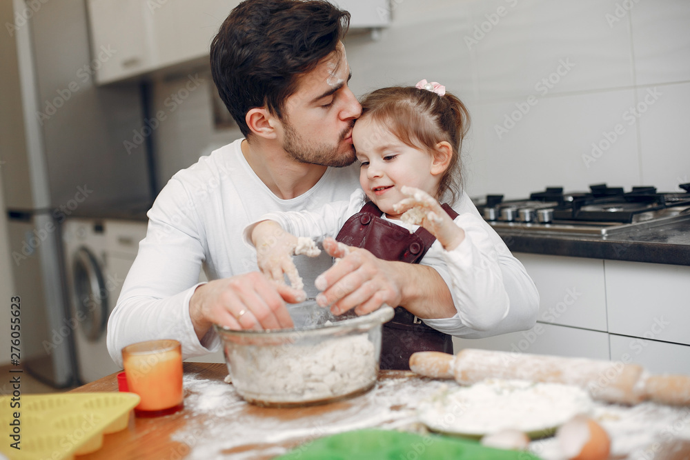 Family in a kitchen. Handsome father with litle daughter Family in a kitchen. Handsome father with litle daughter