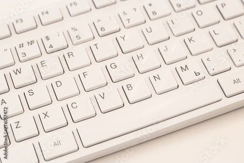 White computer keyboard on a white background, close-up