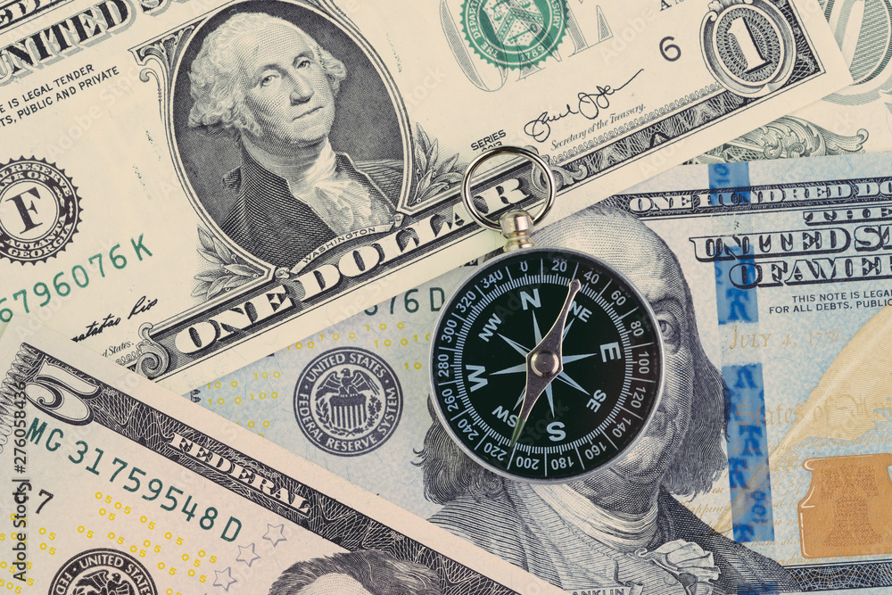 FED, Federal Reserve of US government direction on interest rate concept, compass on US Dollar banknote with Feral Reserve emblem FED, Federal Reserve of US government direction on interest rate concept, compass on US Dollar banknote with Feral Reserve emblem