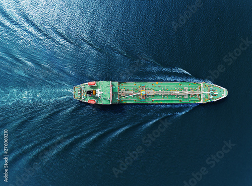 Aerial top view Oil ship tanker full speed transportation oil from refinery on the sea.