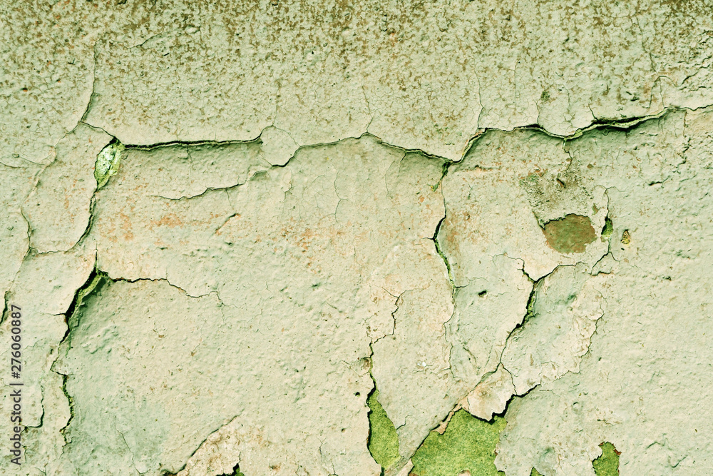 Grunge old painted wall of the house close up green color toned. Abstract background