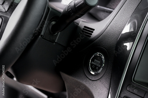 close up start stop button and windscreen wiper switch inside a new car