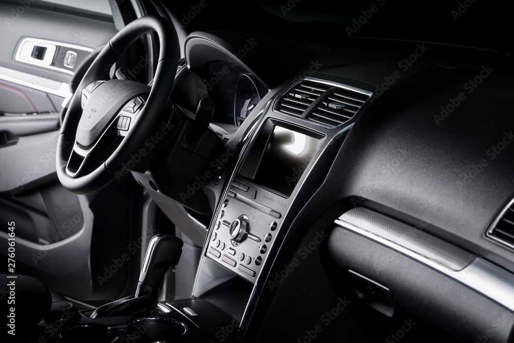 View of the interior of a SUV car, modern dashboard with touch screen, black leather seats ideal for the driver