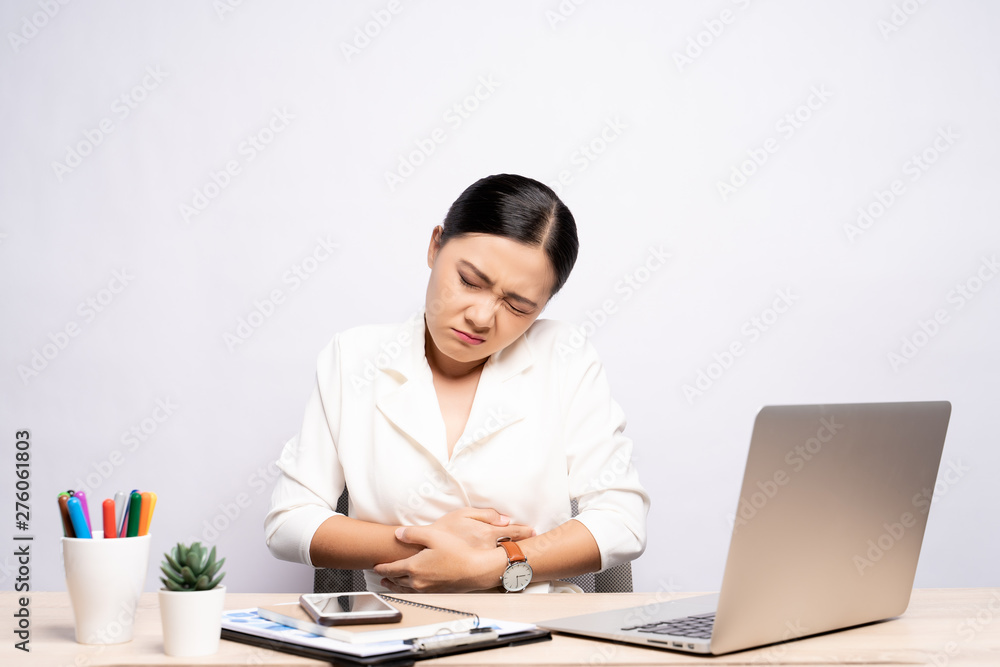 Woman has stomachache at office isolated white background Woman has stomachache at office isolated white background