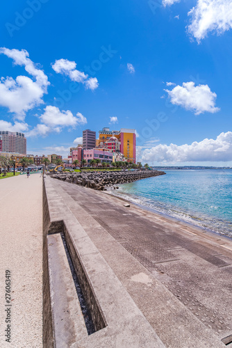 Beach coast lined with palm trees of Distortion Seaside, Oak fashion, Depot Island Seaside buildings and Vessel Hotel Campana in the vicinity of the American Village in Chatan City of Okinawa.