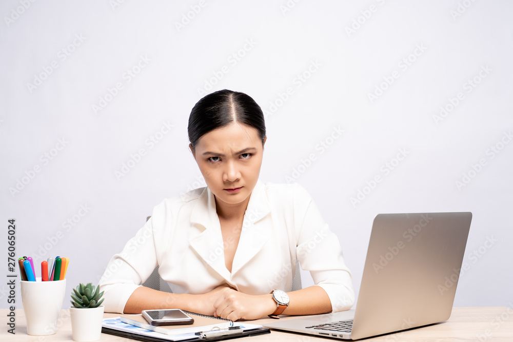 Angry woman working at office isolated over background Angry woman working at office isolated over background