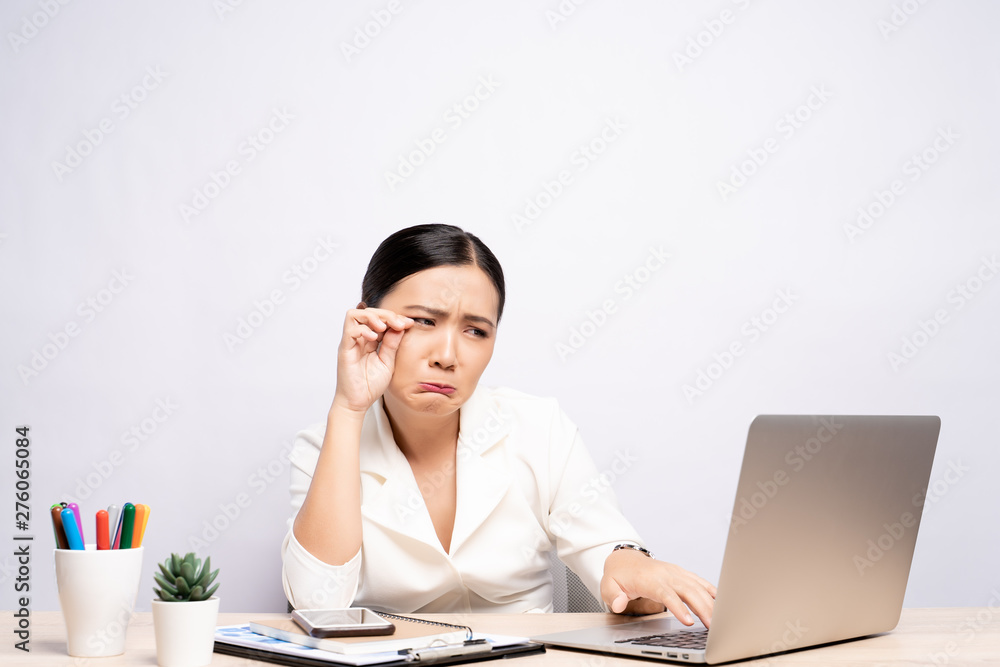 Sad woman crying at office isolated over background Sad woman crying at office isolated over background