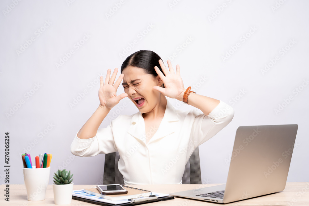 Angry woman screaming at office isolated over background Angry woman screaming at office isolated over background