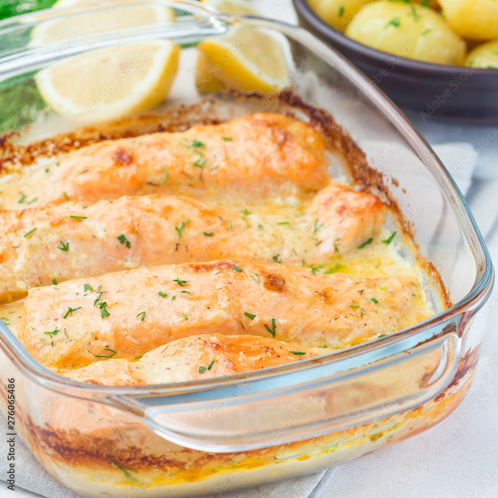 Baked in creamy sauce salmon in glass baking dish, square format Baked in creamy sauce salmon in glass baking dish, square format