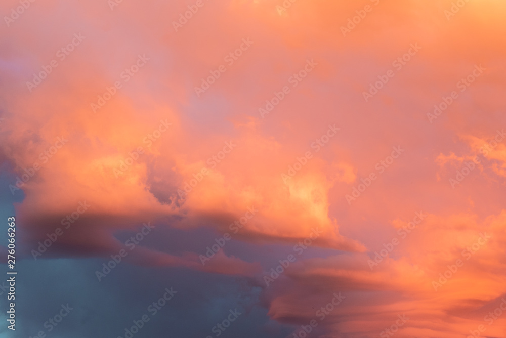 Dramatic orange sky with clouds at sunset. It can be used as a background