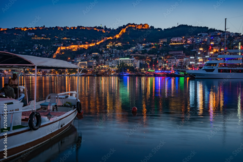 Alanya city, Turkey at night from the pier. Night view of the city of Alanya. Berth for ships.